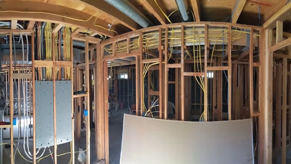 A clean and professional 320A/400A electrical service installation by Bright Haven Electric, showing neatly organized NM-B and SER feeder and branch circuit wires before drywall.