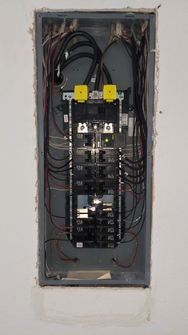 Open electrical panel showing load management wiring